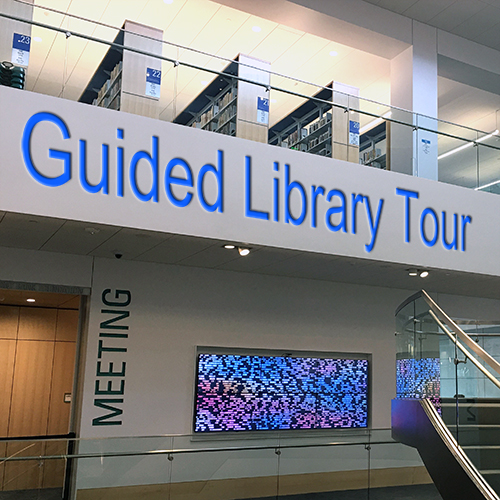View of the Downtown Library's atrium with the words "Guided Library Tour"