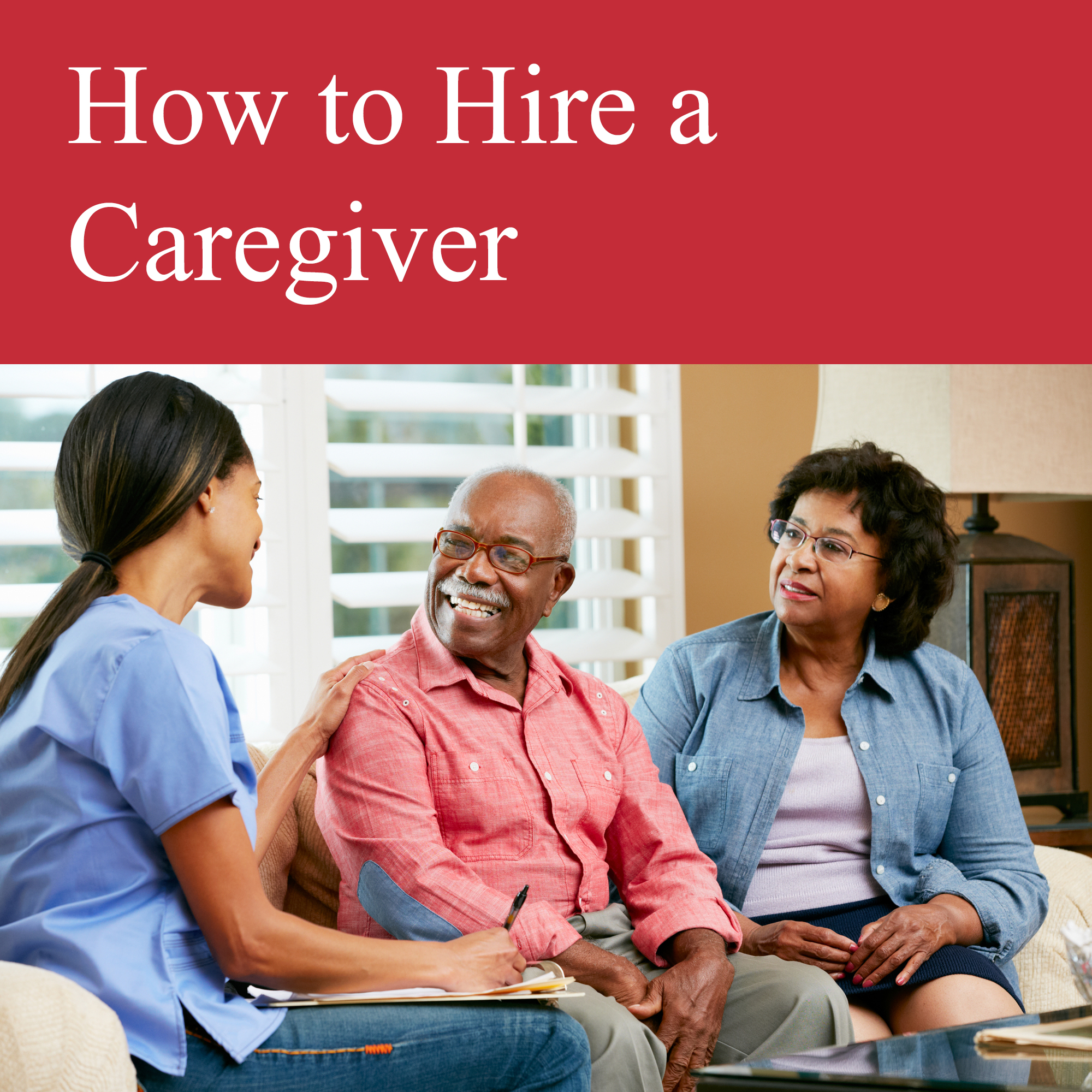 Two older adults sit and talk with a caregiver 