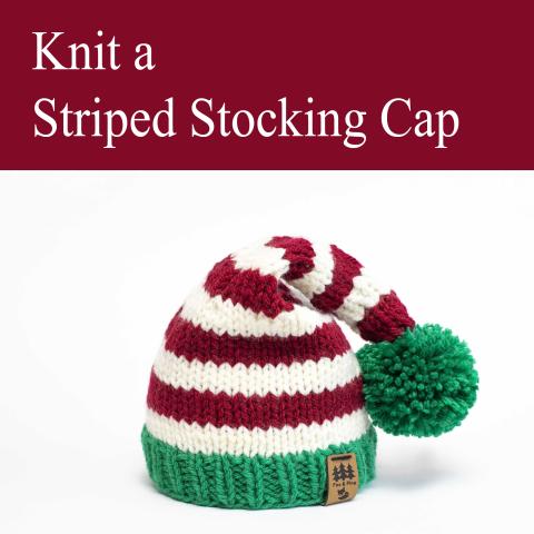 striped stocking cap in red, white, and green with a green pom-pom