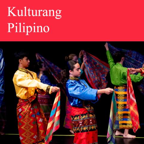 Filipino dancers on a stage wearing various and vibrant traditional garments called Malong.