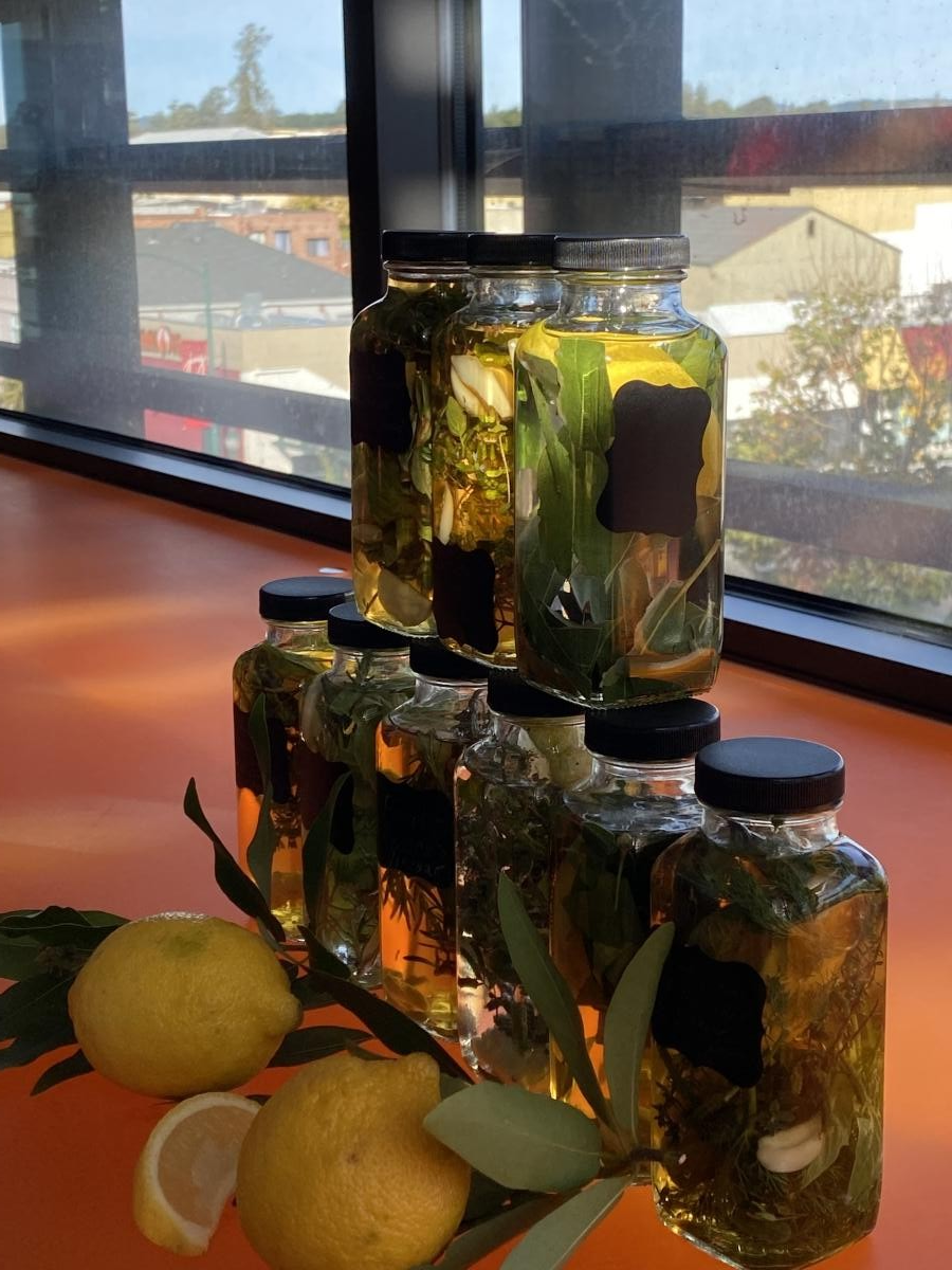 a beautiful stack of bottles with herbs and vinegar inside